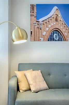 a couch with a lamp and a brick building at Portal de Ruzafa 1 in Valencia