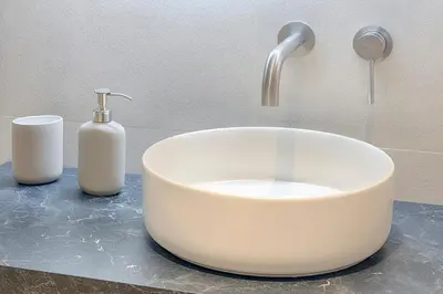 a white sink and a faucet in a bathroom at Portal de Ruzafa 1 in Valencia