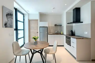a kitchen with a table and chairs in a kitchen at Portal de Ruzafa 2 in Valencia