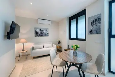 a living room with a table and chairs and a couch at Portal de Ruzafa 2 in Valencia