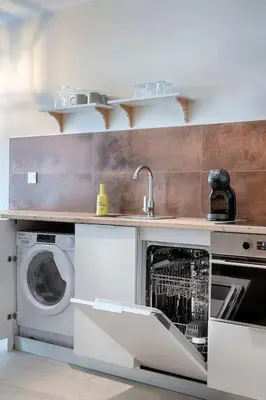 a kitchen with a washing machine and a sink at Ruzafa´s Gate 3 in Valencia