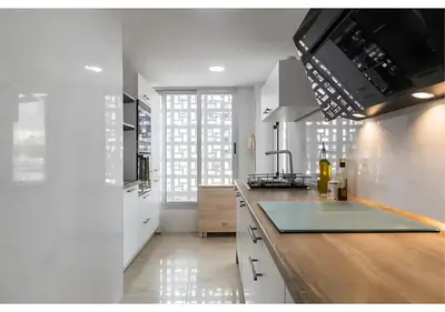 a kitchen with white cabinets and a counter top at El balcón del mar - 1ª línea y frontal al mar in Cullera