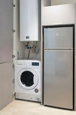 a kitchen with a washing machine and a refrigerator at Portal de Ruzafa 4 in Valencia