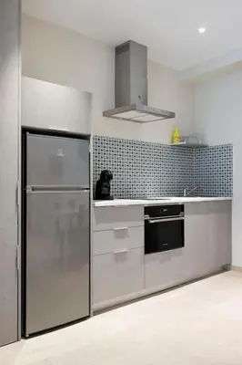 a kitchen with a stainless steel refrigerator and a stove at Portal de Ruzafa 4 in Valencia