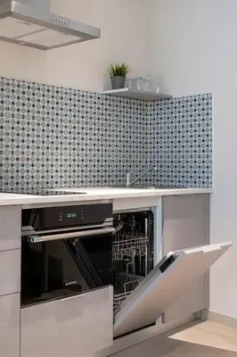 a kitchen with a counter with an oven in it at Portal de Ruzafa 4 in Valencia