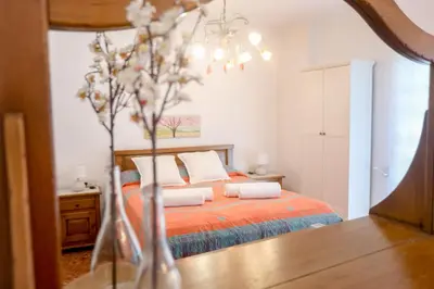 a bedroom with a bed and a vase with flowers at Lovely apartment near the beach & City of Arts and Sciences in Valencia