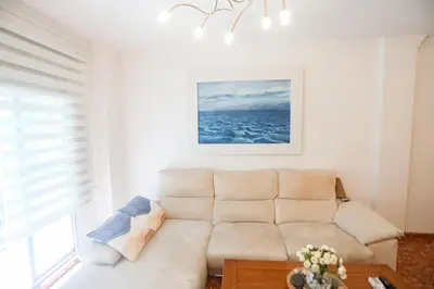 a white living room with a couch and a table at Lovely apartment near the beach & City of Arts and Sciences in Valencia