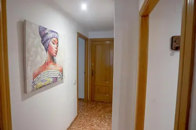 a painting of a woman hanging on a wall at Lovely apartment near the beach & City of Arts and Sciences in Valencia