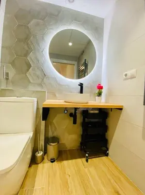 a bathroom with a toilet and a mirror at Relaxing BeachSide Cabanyal Loft in Valencia