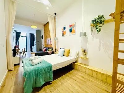 a hotel room with a bed and a table at Relaxing BeachSide Cabanyal Loft in Valencia