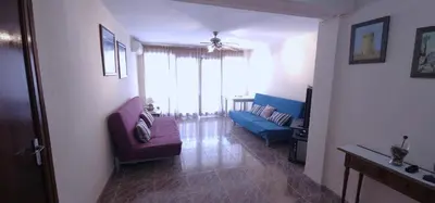 a living room with a couch and a chair at Vacansis Sant Germein in Cullera