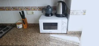a microwave oven with a coffee pot on top of it at Vacansis Sant Germein in Cullera