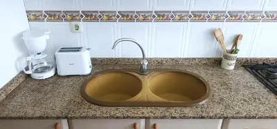 a kitchen counter with a sink with a mixer at Vacansis Sant Germein in Cullera