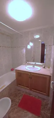 a bathroom with a tub and a sink and a bath tub at Vacansis Sant Germein in Cullera