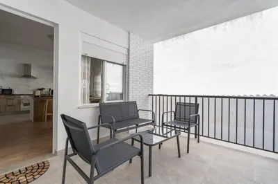 two chairs and a table on a balcony at Apartamentos Borriana in Burriana