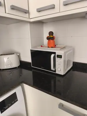 a toy sitting on top of a microwave in a kitchen at Apartamento Sunshine Grao in Burriana