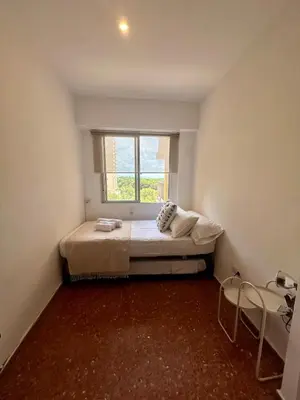 a bedroom with a bed in a room with a window at District Key - Saler, Av Gola Puchol 14 in Valencia