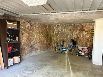 a bike parked in a room with a stone wall at Beauty Garden in Cullera