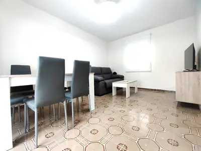 a living room with a table and chairs and a couch at Apartamentos rurales Villamalur in Villamalur