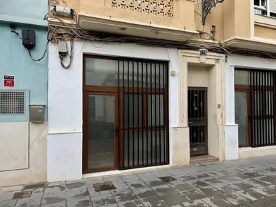 a building with wooden doors on a street at Cabanyal Apto luminoso y playa in Valencia