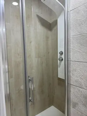 a shower with a glass door in a bathroom at Cabanyal Apto luminoso y playa in Valencia