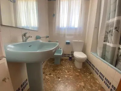 a bathroom with a sink and a toilet at Maripatri Solo Familias Serviplaya!!! in Casas Las Basas