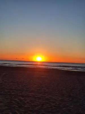 a sunset on a beach with the ocean at Casa Abanico in Cullera in Cullera