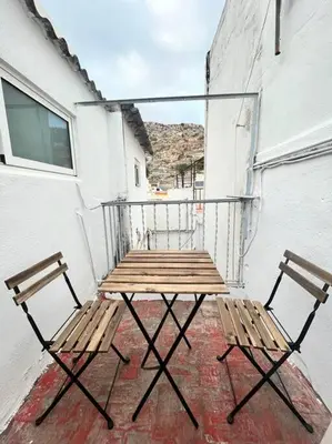 a table and two chairs sitting on a balcony at Casa Abanico in Cullera in Cullera