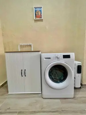 a washing machine sitting next to a dryer in a room at Casa Abanico in Cullera in Cullera