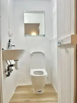 a small bathroom with a toilet and a sink at Casa Abanico in Cullera in Cullera