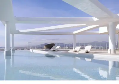a swimming pool with white chairs and water at 