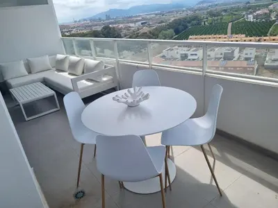 a white table and chairs on a balcony at 