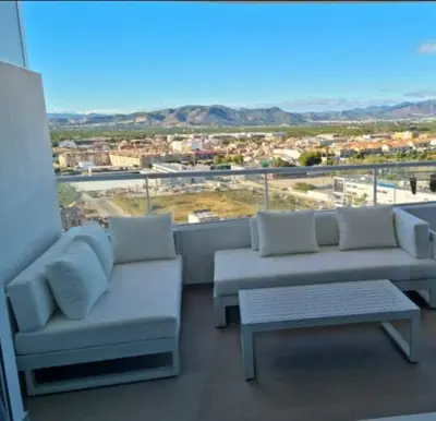 a balcony with couches and a view of a city at 