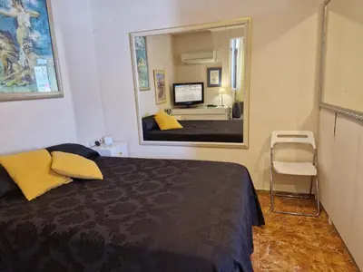 a bedroom with a bed and a large mirror at Style Apartments City Center in Valencia