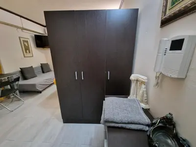 a room with a large wooden cabinet and a couch at Style Apartments City Center in Valencia
