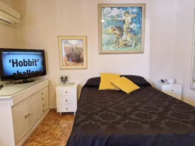 a bedroom with a bed and a flat screen tv at Style Apartments City Center in Valencia