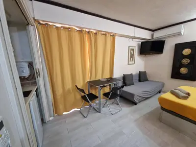 a room with a bed and a table and a couch at Style Apartments City Center in Valencia