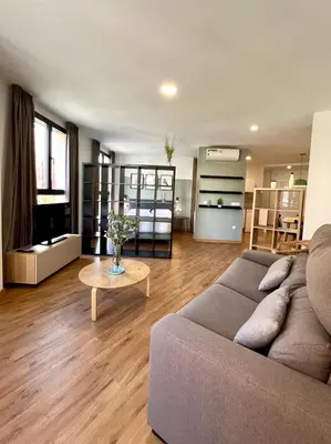 a living room with a couch and a table at Apartamentos de Pradas in Valencia