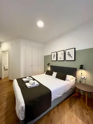 a bedroom with a large bed with towels on it at Apartamentos de Pradas in Valencia