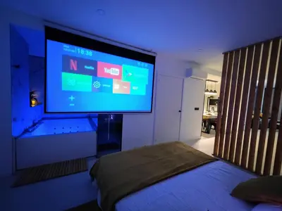 a bedroom with a large television on the wall at Sweet Suites in Valencia