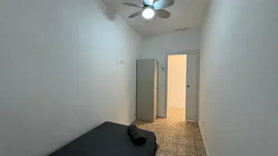 a room with a ceiling fan and a bed in it at Cabañal Retreat in Valencia