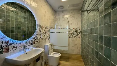 a bathroom with a sink and a toilet and a mirror at Cabañal Retreat in Valencia