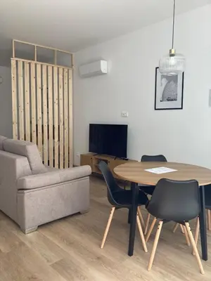 a living room with a table and a chair and a couch at Dormavalencia Crónica in Valencia
