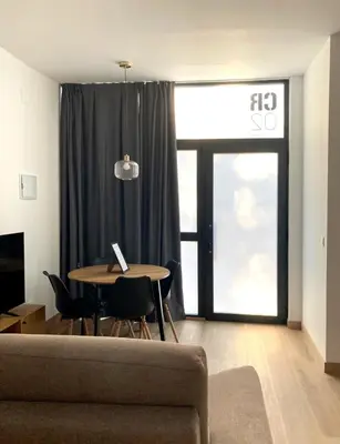 a living room with a table and a couch at Dormavalencia Crónica in Valencia