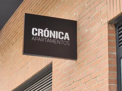 a sign on the side of a brick building at Dormavalencia Crónica in Valencia