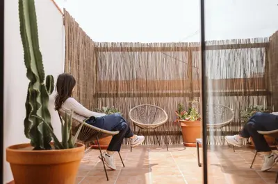 a woman sitting in a chair on a patio at Lindala Natural in Valencia