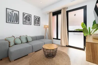 a living room with a couch and a table at Travel Habitat Bioparc Apartments in Valencia