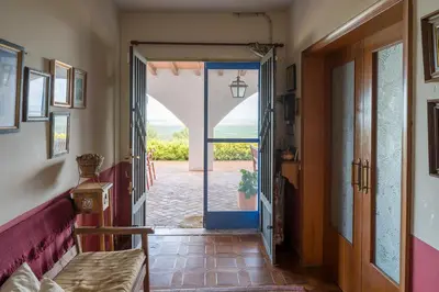 a hallway with an open door with a view of the ocean at House -Sleeps 8-Natural Pool-Pet Friendly in Artana