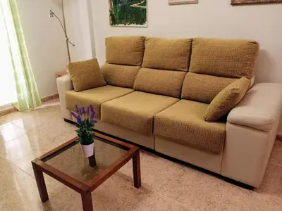 a living room with a couch and a coffee table at Apartamento playa de Canet WIFI in Canet de Berenguer