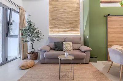 a living room with a couch and a table at GREEN&FRESH Apartament in Valencia